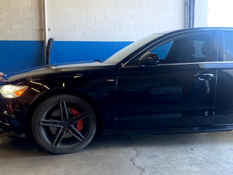 Sedan in the Palmdale Smog Check test bay