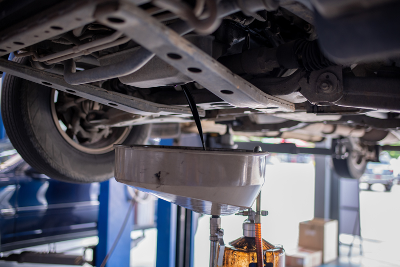 Fresh motor oil being poured into an engine